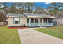 Charming home with a screened-in porch, green trim, and well-maintained lawn at 1618 Yost Ln, Johns Island, SC 29455