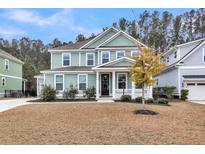 Charming two-story home features a welcoming front porch and manicured landscaping at 295 Calm Water Way, Summerville, SC 29486
