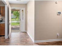 Inviting foyer featuring wood-look floors and a view of the outdoors through the storm door at 303 Hamlet Rd, Summerville, SC 29485