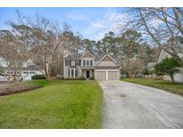 Charming two-story home with a well-manicured lawn and a two-car garage at 3216 Rose Walk Ct, Mount Pleasant, SC 29466
