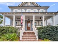 Charming two-story home featuring a welcoming front porch, columns, and tasteful landscaping at 3736 Goodwater St, Mount Pleasant, SC 29466