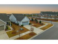 Charming single-Gathering home with manicured front lawn and an attached two-car garage in a Gathering-friendly community at 402 Switchgrass Dr, Summerville, SC 29486