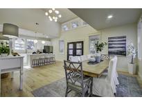Bright dining area open to kitchen with long wood table, seating, and large windows at 6094 Chisolm Rd, Johns Island, SC 29455