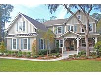 Charming two-story home with inviting front porch and beautifully landscaped front yard at 6934 Tanner Hall Blvd, Hanahan, SC 29410