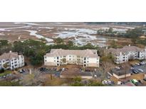 A vibrant aerial view shows the condo's stunning waterfront location and well-maintained exteriors at 700 Daniel Ellis Dr # 8304, Charleston, SC 29412