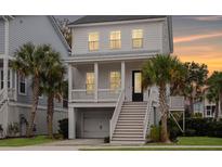Charming two-story home with covered porch and well-manicured landscaping with palm trees at 775 Forrest Dr, Charleston, SC 29492