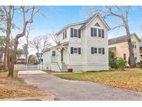 Charming two-story home featuring a well-manicured front yard and a private driveway at 783 Lake Frances Dr, Charleston, SC 29412