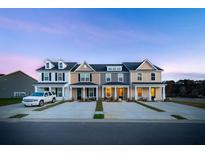 View of newly constructed townhomes boasting craftsman-style architecture and well-manicured lawns at 826 Alma Square Dr, Moncks Corner, SC 29461