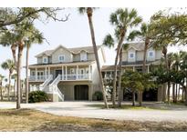 Charming two-story coastal home featuring a spacious porch and beautiful architectural details at 10 Toms Turnaround Cir, Edisto Island, SC 29438