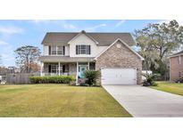 Charming two-story home with brick facade, large front lawn, and welcoming front porch at 1106 Mccrae Dr, Moncks Corner, SC 29461