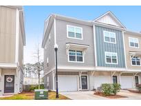 Charming two-story townhome with attached one car garage and colorful exterior design at 1241 Allusion Ln, Mount Pleasant, SC 29466