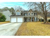 Charming two-story home featuring a two-car garage, well-kept lawn, and traditional architectural details at 129 Isherwood Dr, Goose Creek, SC 29445