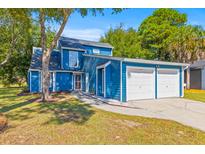 Bright blue two-story home with a two car garage and freshly landscaped front yard at 1370 Little David Ct, Charleston, SC 29412