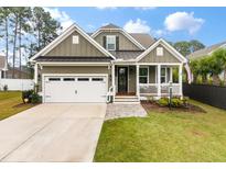 Charming home featuring a welcoming front porch, well-manicured lawn, and two-car garage at 1502 Checker Ct, Mount Pleasant, SC 29466