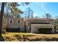 Inviting two-story home with manicured landscaping and charming exterior details at 2015 Albert Storm Ave, Moncks Corner, SC 29461