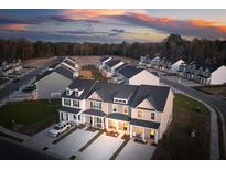 Aerial view of new construction townhomes featuring covered front porches and garages in a modern community at 207 Abercom Place Dr, Moncks Corner, SC 29461