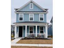 Charming two-story home with a covered front porch and manicured lawn at 2221 Blue Bayou Blvd, Johns Island, SC 29455