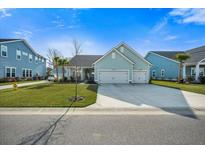 Charming single Gathering home featuring a spacious driveway, two-car garage, and well-manicured lawn at 2379 Lenwick Hall Ln, Johns Island, SC 29455