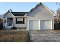 Charming home featuring a two-car garage and inviting front porch at 241 Two Hitch Rd, Goose Creek, SC 29445