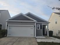 Charming home with a two-car garage, landscaped front yard, and attractive curb appeal at 9715 Brandishing Rd, Ladson, SC 29456