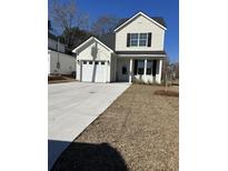 Charming two-story home featuring a welcoming front lawn and private garage at 3004 Harvey Ave, North Charleston, SC 29405