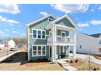 Charming two-story home featuring a covered porch and a well-maintained front yard at 304 O'Malley Dr, Summerville, SC 29483