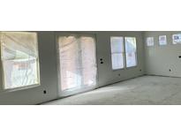 Bright living room featuring multiple windows and a sliding glass door at 324 Abercom Place Dr, Moncks Corner, SC 29461