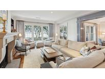 Bright living room features a fireplace, large windows and comfortable seating at 32-E Prioleau St, Charleston, SC 29401