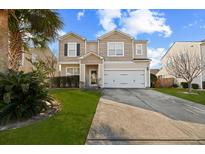 Charming two-story home featuring a well-manicured lawn, neutral siding, and an attached two-car garage at 432 Stoney Field Dr, Moncks Corner, SC 29461