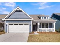 Charming home featuring a two-car garage, craftsman-style accents, and a welcoming front porch at 4996 Song Sparrow Way, Summerville, SC 29483