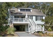 Charming two-story beach home with a covered parking area and a cozy front porch at 524 Cobby Creek Ln, Seabrook Island, SC 29455