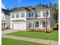 Charming two-story home with gray shutters, a two-car garage, and a well-manicured front lawn at 606 Dunswell Dr, Summerville, SC 29486