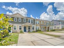 Attractive townhome featuring multiple units, each showcasing a unique color scheme, and offering ample parking space at 7857 Montview Rd, North Charleston, SC 29418