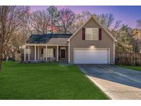 Charming two-story home featuring a well-manicured lawn and an attached two-car garage at 101 Eagle St, Ladson, SC 29456