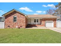 Charming brick home with a well-manicured lawn and an attached garage, perfect for suburban living at 103 Sycamore Dr, Summerville, SC 29485
