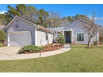 Charming single-story home featuring manicured lawn, tidy landscaping, and attached two-car garage at 106 Ranworth Ln, Summerville, SC 29485