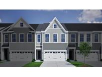 Modern townhome featuring multi-tone gray siding, a two-car garage, and manicured landscaping at 116 Brown Swiss Cir, Summerville, SC 29483