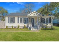 Charming home with a well-manicured lawn and inviting front porch at 1324 Maxwell St, North Charleston, SC 29405
