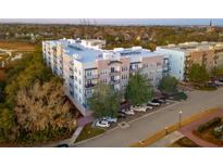 Beautiful new luxury apartment building with brick facade and balconies; well-manicured landscaping surrounds at 145 Pier View St # 403, Charleston, SC 29492