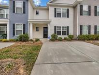 Charming multi-colored townhome with black shutters and a concrete driveway at 246 Spencer Cir, Summerville, SC 29485