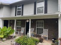 Charming townhome with a quaint front porch, rocking chairs, and well-maintained landscaping at 2494 Etiwan Ave # J-8, Charleston, SC 29414