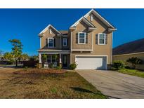 Charming two-story home with tan siding, black shutters, and well-manicured lawn at 2734 Sunrose Ln, Johns Island, SC 29455