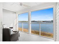 Inviting sunroom featuring serene water views and comfortable seating to enjoy the peaceful waterfront scenery at 46 Mariners Cay Dr, Folly Beach, SC 29439