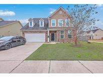 Charming two-story home features a brick facade, attached garage, and well-manicured lawn at 508 Adalina Dr, Goose Creek, SC 29445
