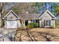 Charming one-story home featuring attached garage and manicured lawn at 510 Village Rest Ct, Mount Pleasant, SC 29464