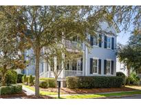 Charming two-story home boasts manicured landscaping, classic shutters, and inviting front porch at 914 Tupelo Bay Dr, Mount Pleasant, SC 29464