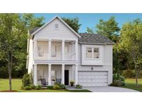 Charming two-story home with covered front porch and balcony, complemented by lush landscaping and a two-car garage at 1016 Swamp Rose Run, Summerville, SC 29485
