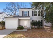 Charming two-story home with a manicured front yard and an attached one-car garage at 2028 Wild Flower Lane, Charleston, SC 29414