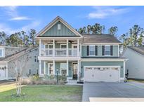 Charming two-story home with covered porch, second-story balcony, and two-car garage at 207 Calm Water Way, Summerville, SC 29486