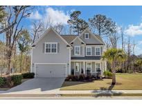 Charming two-story home with gray siding, well-maintained landscaping, and an attached two-car garage at 2825 Backman St, Mount Pleasant, SC 29466